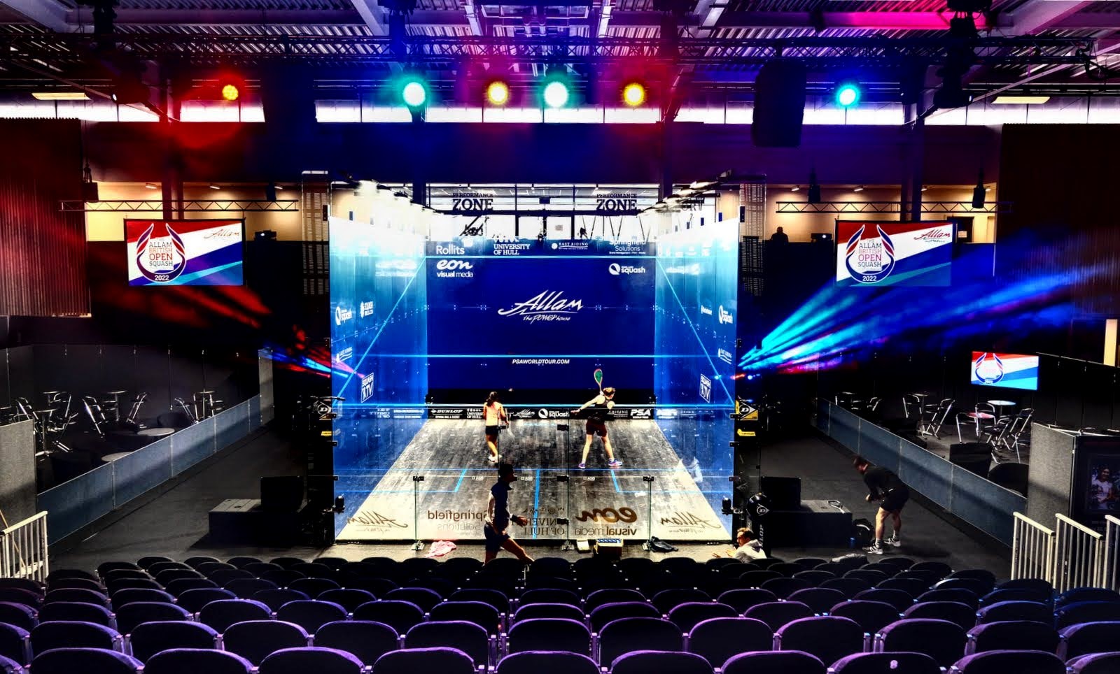 Image of a squash court with bright lights of red and blue